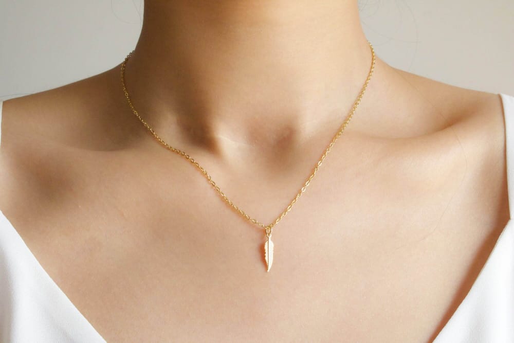 Golden necklace weared in neck of woman